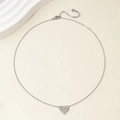 Close-up of silver heart pendant necklace with fine stones on a delicate O-chain - 14k / Steel