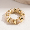 Detail of bohemian elastic bracelet with marble textured beads and gold geometric spacers - Round Bead Geometric Metal Stretch Bracelet / Bracelet-White
