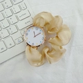 Detailed macro view of gold watch dial with colorful markers and beige silk ribbon strap - Beige