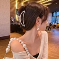 Detail of elegant large pearl hair claw clip with matching earrings and accessories - Elegant Crescent Pearl Claw