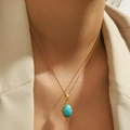 18K gold plated titanium necklace featuring a vintage oval turquoise pendant on a model - Oval Turquoise (DJN023GL)