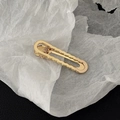Golden wavy hollow metal duckbill hair clip on a minimalist black and white background - Gold Wave Hollow Style B