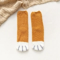 Plush coral fleece socks in brown with cute white animal paw pattern for winter warmth - One Size / Turmeric