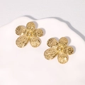 Elegant gold flower stud earrings with hammered texture on a white ceramic tray - Gold