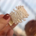 Elegant gold metal ponytail clip adorned with white pearls and a rabbit design - Wavy Gold Pearl