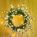 Circular LED firecracker string lights with warm white beads on green wire - 1.5m 50LED USB Remote 8 Functions - Green Wire Warm Light