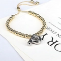 Detail of adjustable gold beaded bracelet featuring a silver 3D balloon initial P charm - Letter P