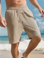 Detail of khaki men's striped shorts featuring textured crinkle fabric and drawstring waist - S / Khaki