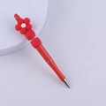 Detailed view of red silicone beaded pen featuring creative flower decor and metal tip - Red