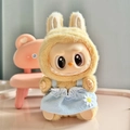 Labubu doll wearing a yellow plush hoodie and blue daisy dress variant accessory - Blue Daisy Charm Strap / First And Second Generation Keychains Are Compatible With La Cloth Dolls. Dolls Not Included.