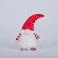 Close-up of a festive Christmas gnome plush with sequins and a warm glowing light - Red