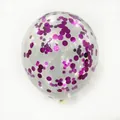Macro detail of transparent latex balloon with metallic magenta sequins for party decor - Magenta Confetti
