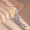Detail of silver drop earrings with zircons draped over beige marble texture - Silver Zirconia Water Drop Necklace