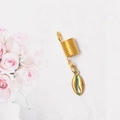 Close-up of golden metal dreadlock ring with a delicate shell pendant accessory - Small Conch Style