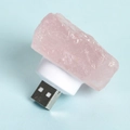USB night light featuring natural pink crystals on a white base against a blue background - Rose Quartz