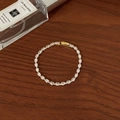 Exquisite gold-plated tennis bracelet with marquise-cut zircons on a wooden table - Full Zircon Marquise