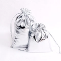 Macro shot of silver metallic drawstring gift bags in two sizes for jewelry storage - 20x30cm / Silver