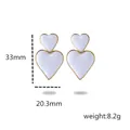 Boucles d'oreilles double cœur blanc en acier doré 18K avec détail de 33 mm - Blanc