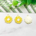Macro shot of three daisy alloy enamel flower pendants on marble surface with gold back detail - 16x18mm / Yellow