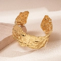 Detailed close-up of golden wide open cuff bracelet with irregular hammered texture - Bracelet-Gold
