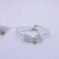 Close-up of white lace choker with satin bow and golden bell for costume dress up - White Choker