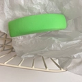 Detail view of a bright green rectangle fabric hair clip with a fine twill texture finish - Green