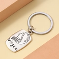 Macro detail of silver alloy Virgo zodiac keychain featuring an engraved artistic portrait - Virgo