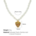 Golden heart necklace with freshwater pearls and colorful rhinestones on a white surface - Multi-color Heart Pendant + Freshwater Pearl Chain