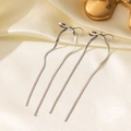 Detail of silver long tassel bow earrings with flat snake chains on silk fabric - Bowknot Earrings / Steel