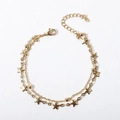 Close-up of a double-layer gold chain bracelet with star charms and adjustable clasp - 17+5cm / Cross Bead Chain + Five-pointed Star Bracelet / Gold