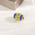 Macro shot of oval gold bead with blue enamel and green zircon for DIY jewelry making - Blue