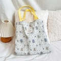 Detail of floral bear pattern and blue stripes on cotton canvas tote with yellow strap - Badge Bear
