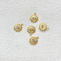 Detailed macro view showing five 14k gold plated evil eye sunburst charms with zircon - Gold