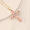 Gold cross necklace with pink enamel and multicolor zircons on a ceramic tray - Rose Red