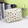 Detail of quilted cosmetic bag featuring cute bear and floral prints in a cozy room setting. - New Quilted Flower Bear Cosmetic Bag
