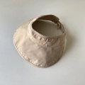 Detail of beige sun visor showing breathable mesh lining and adjustable elastic drawstring - Beige
