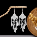 Detail of vintage silver-tone earrings with leaf fringe and heart charms on a wooden branch - Silver Fan Heart Pointed Cone Tassel Style (E2873-35)