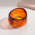 Macro detail of amber resin bracelet with marbled texture and translucent finish - Coffee Wide (Amber Texture Glossy)