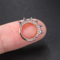 Close-up of rose gold crown ear hoop with blue and clear marquise zircons on finger - Style CC007-3 / Crown Hoop / Blue Stone White Gold