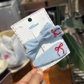 Light blue fabric hair clip set with red bow embroidery and branding on display card - Haze Blue and Red Bow Clip Set