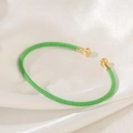 Detail showing green braided bracelet with polished gold-tone metal ball ends - Bright Green