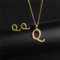 Detail of gold letter Q pendant necklace and matching stud earrings on black background - Letter Q / Gold