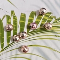 Detail von roségoldenen facettierten Perlen für DIY-Schmuck mit Löchern auf weißem Grund - 10mm / UV roségold beschichtet