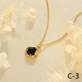 Close-up of gold irregular pendant necklace with central black gemstone and dainty chain - Black Agate without Zirconia