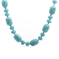 Handcrafted turquoise necklace with irregular oval beads and round stones on white background - Blue Turquoise