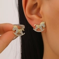 Golden rocking horse stud earrings with white zircon inlays worn by a model - Pave Rhinestone Rocking Horse / 14k Light Gold Pave Rhinestone Rocking Horse (6288)
