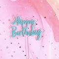 Detail of teal Happy Birthday acrylic cake topper over a dreamy pink tulle background - Green