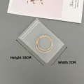 Detailed view of 7x10cm transparent EVA jewelry bag with golden twisted hoop earrings - 40 Silk Frosted Self-Sealing Bag / 7x10cm