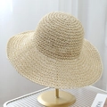 Detail of natural beige woven straw hat on gold stand with wide brim texture - 10cm Brim (Shaping Wire) / Beige