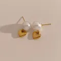 Elegant gold heart earrings with white pearl studs on a warm minimalist background - Gold Kde2209